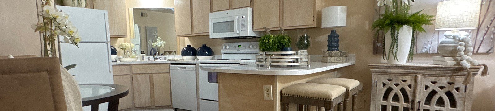 A kitchen with a white refrigerator and wooden cabinets.